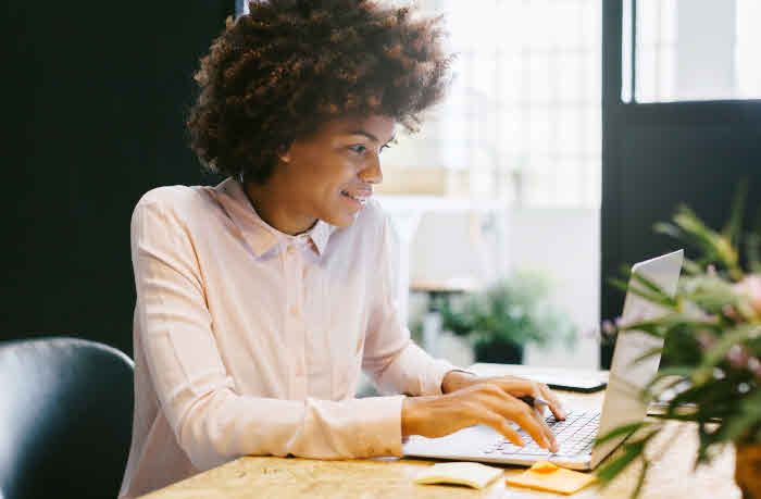 Woman typing on a laptop