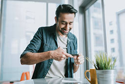 man depositing check with smartphone